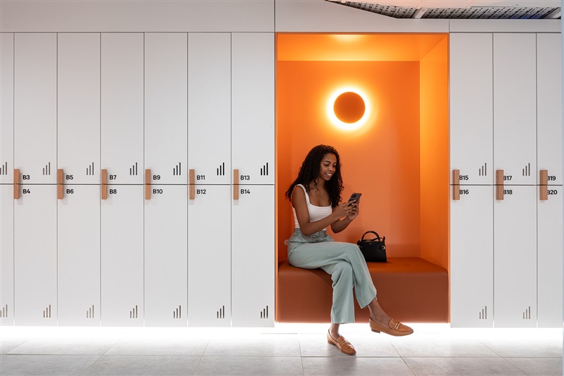 Luxury spa lockers with wood touches and orange seating section